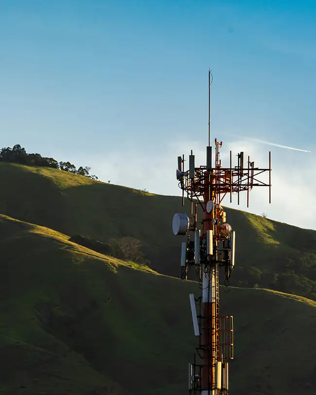 Telecommunications mast on a hillside